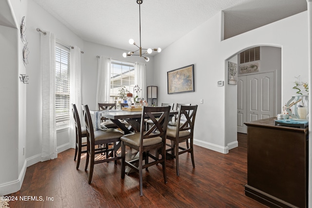 dining area featuring an inviting chandelier, dark hardwood / wood-style floors, and a textured ceiling