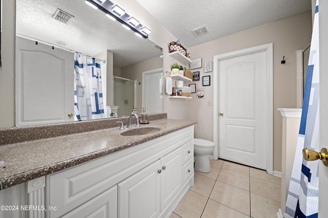 bathroom featuring vanity, curtained shower, a textured ceiling, tile patterned floors, and toilet