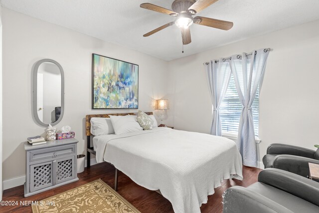 bedroom featuring ceiling fan and dark wood-type flooring