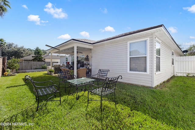 back of property featuring a yard and a patio area