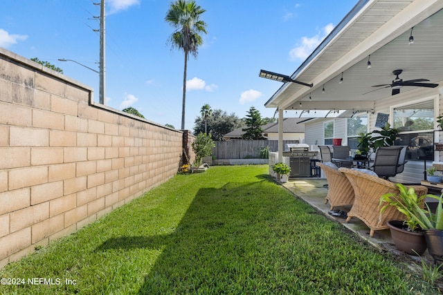 view of yard featuring a patio and ceiling fan