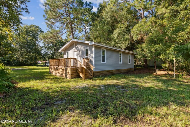 back of property featuring a yard