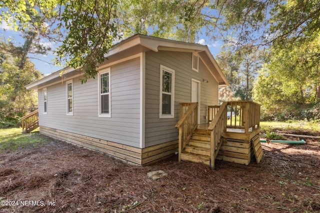 view of side of home with a wooden deck