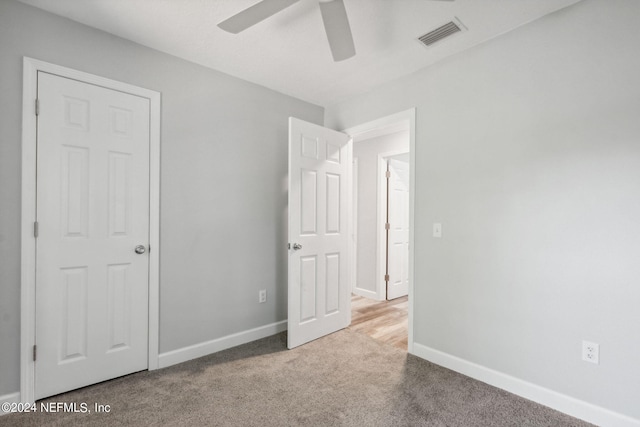 unfurnished bedroom featuring ceiling fan and light colored carpet