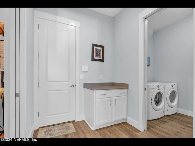 washroom with separate washer and dryer and light hardwood / wood-style flooring