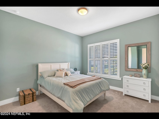 bedroom featuring light carpet