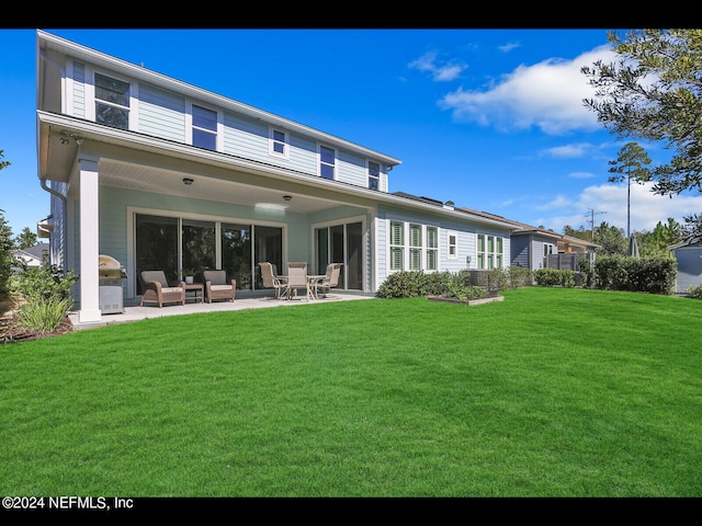 back of house with an outdoor hangout area, a lawn, and a patio