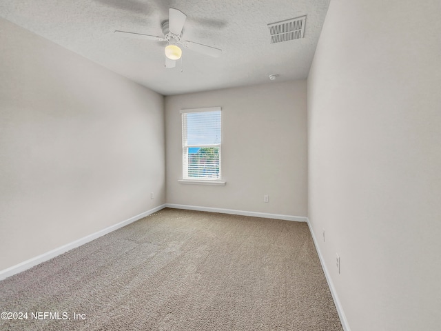 unfurnished room featuring ceiling fan, carpet flooring, and a textured ceiling