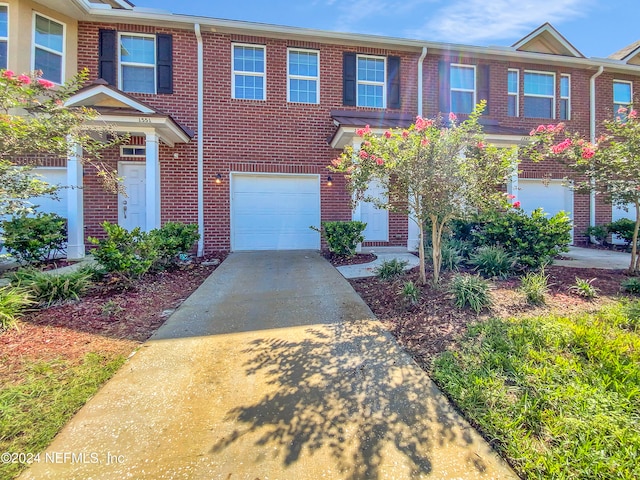 multi unit property featuring a garage