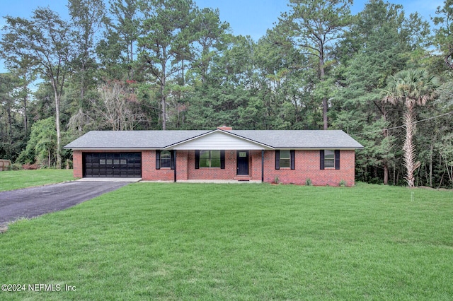 single story home with a garage and a front lawn