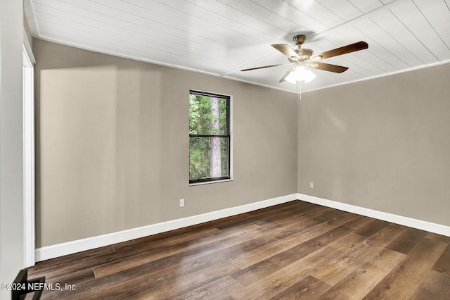 spare room with wooden ceiling, dark wood-type flooring, and ceiling fan