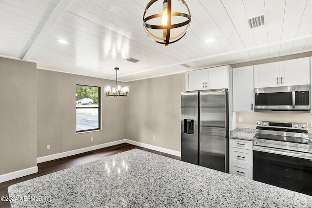 kitchen with light stone counters, white cabinetry, appliances with stainless steel finishes, decorative light fixtures, and dark hardwood / wood-style flooring