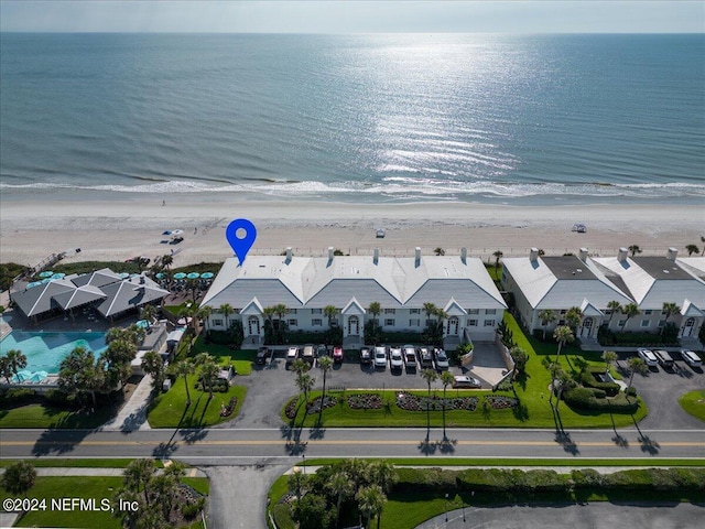 drone / aerial view with a water view and a beach view