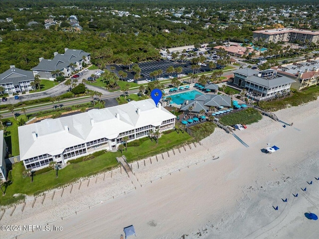 aerial view with a water view and a beach view