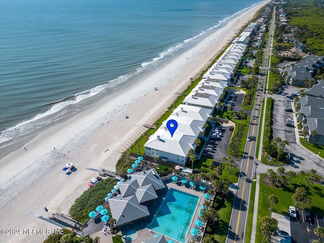 bird's eye view with a water view and a beach view