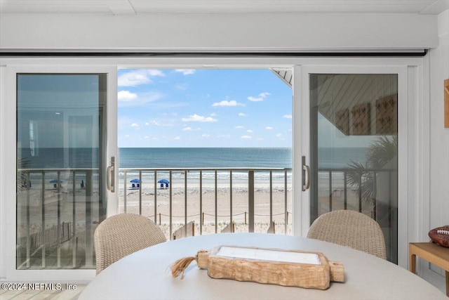 balcony with a water view and a beach view