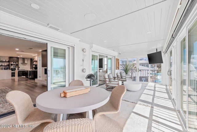 sunroom / solarium featuring wood ceiling