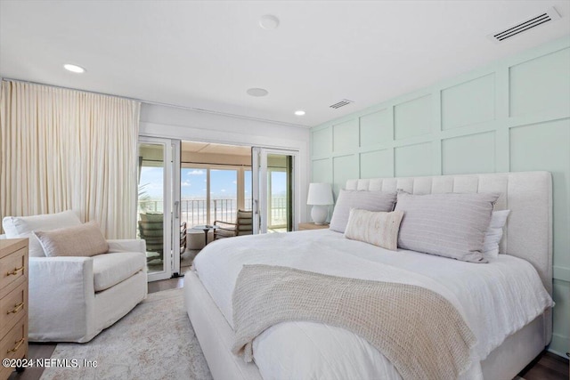 bedroom with light wood-type flooring and access to outside