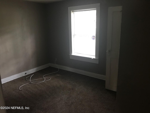 carpeted spare room with a healthy amount of sunlight