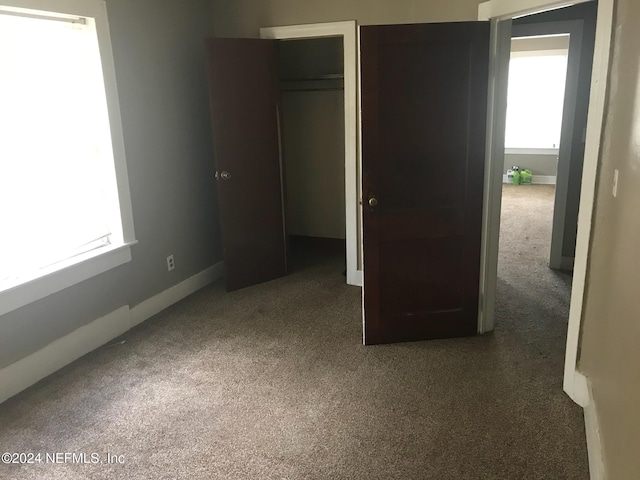 unfurnished bedroom with carpet floors and a closet