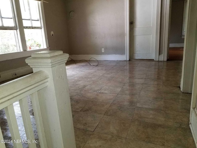 empty room with tile patterned flooring