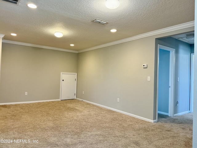 carpeted empty room with crown molding and a textured ceiling