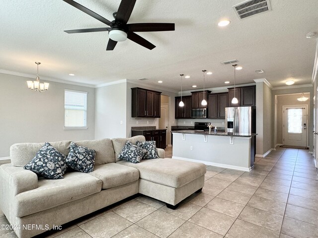 living room featuring a textured ceiling, ceiling fan with notable chandelier, a wealth of natural light, and crown molding