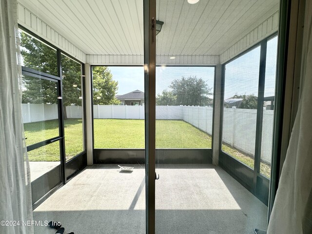 unfurnished sunroom featuring wood ceiling