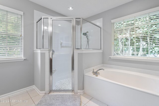 bathroom featuring shower with separate bathtub and tile patterned floors