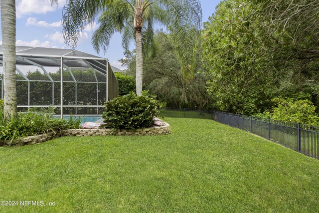 view of yard featuring a lanai and a fenced in pool