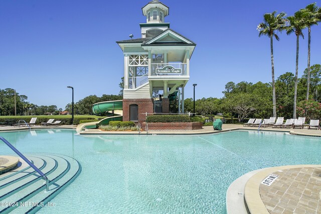 view of swimming pool with a water slide