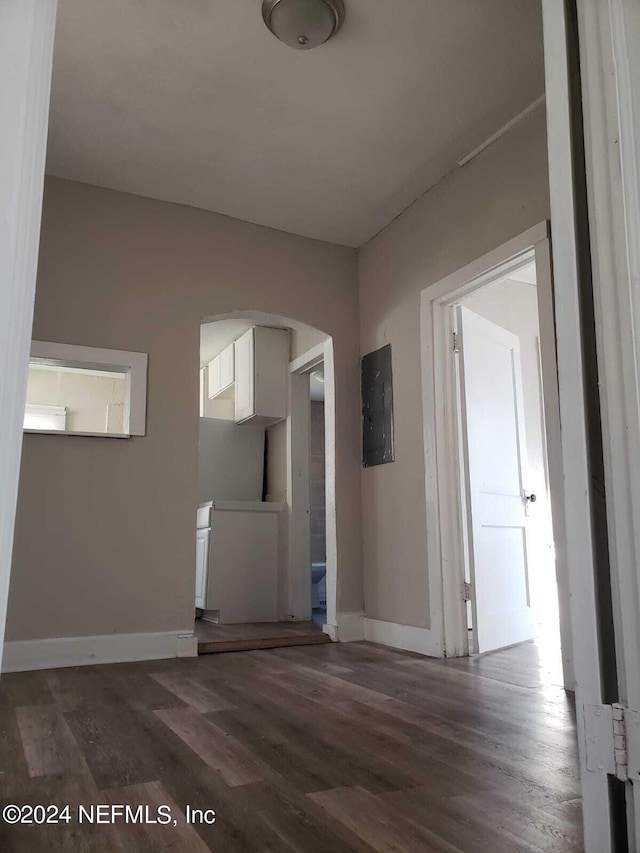 unfurnished living room featuring dark hardwood / wood-style flooring