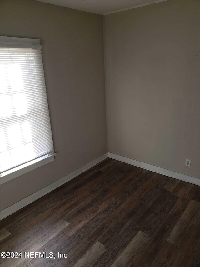 unfurnished room featuring dark wood-type flooring