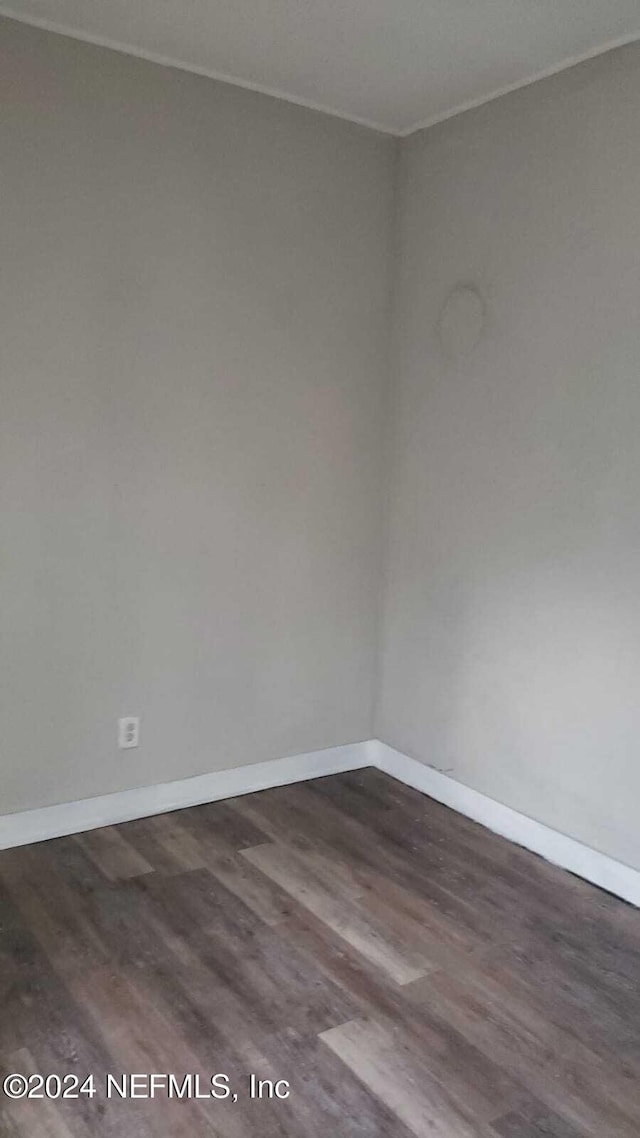 spare room featuring dark hardwood / wood-style flooring