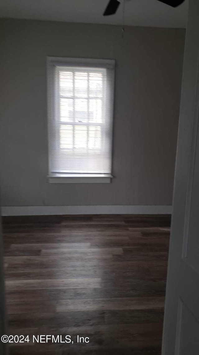 unfurnished room featuring ceiling fan and dark hardwood / wood-style floors