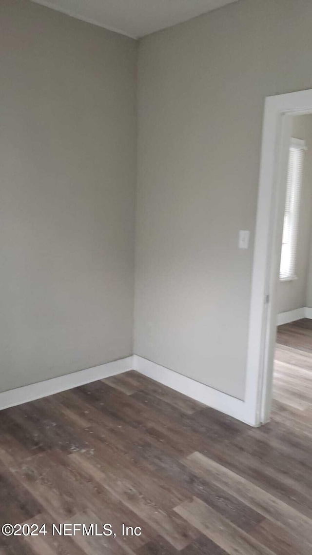 empty room featuring dark wood-type flooring