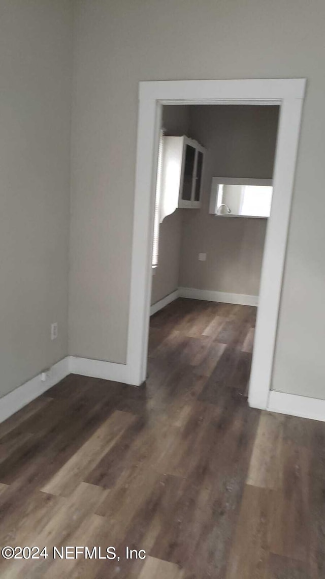 spare room with dark hardwood / wood-style floors