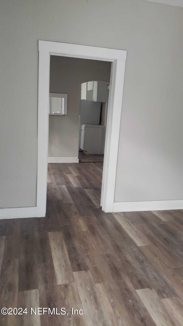 corridor featuring dark hardwood / wood-style floors