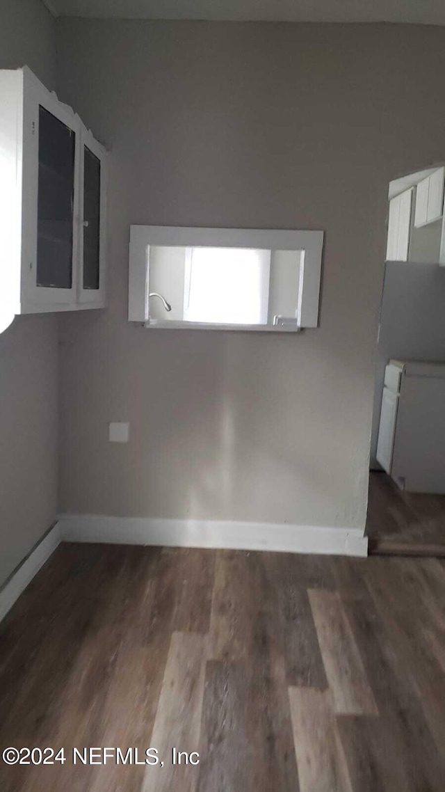 unfurnished room with hardwood / wood-style flooring