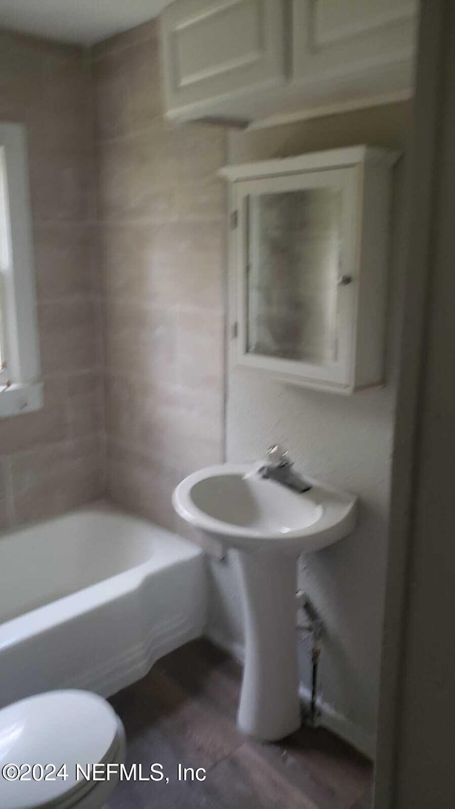 bathroom featuring wood-type flooring and toilet