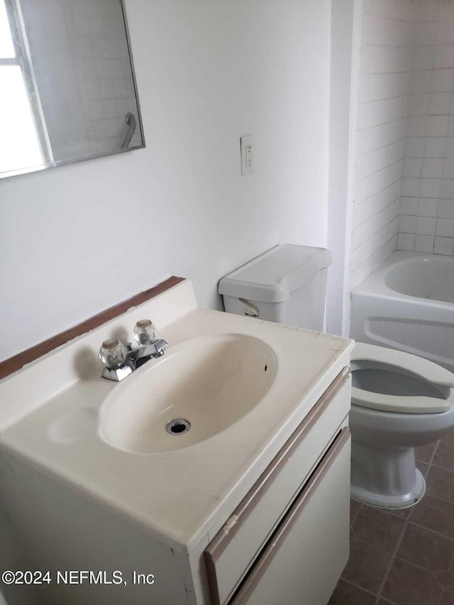 full bathroom with tiled shower / bath combo, vanity, toilet, and tile patterned floors