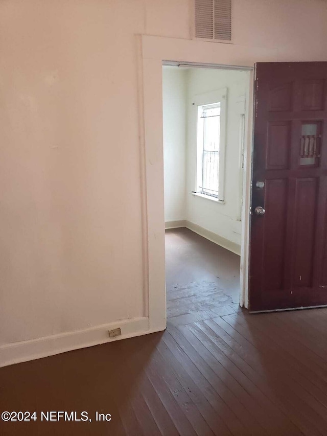 entryway with dark hardwood / wood-style flooring