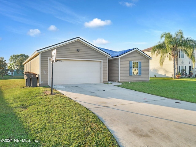 ranch-style house featuring a front lawn and a garage