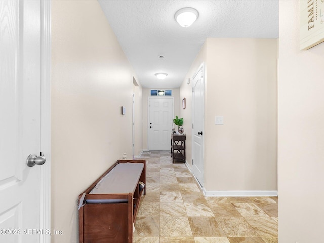 corridor featuring a textured ceiling