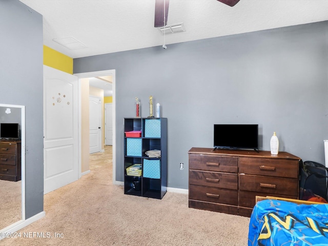 bedroom with light carpet and ceiling fan