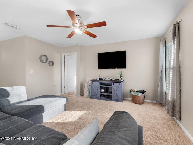 carpeted living room with ceiling fan