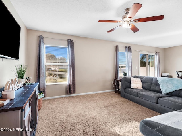 carpeted living room featuring a textured ceiling, plenty of natural light, and ceiling fan