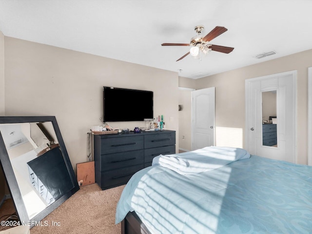 bedroom featuring light carpet and ceiling fan