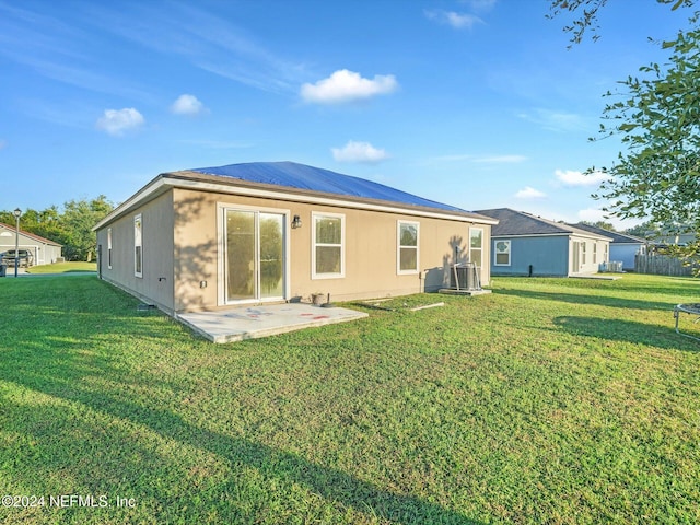 rear view of house with a yard and a patio