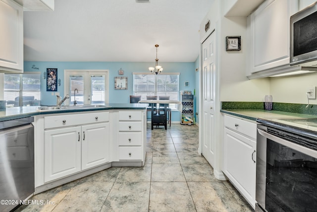 kitchen featuring white cabinets, hanging light fixtures, sink, a chandelier, and stainless steel appliances